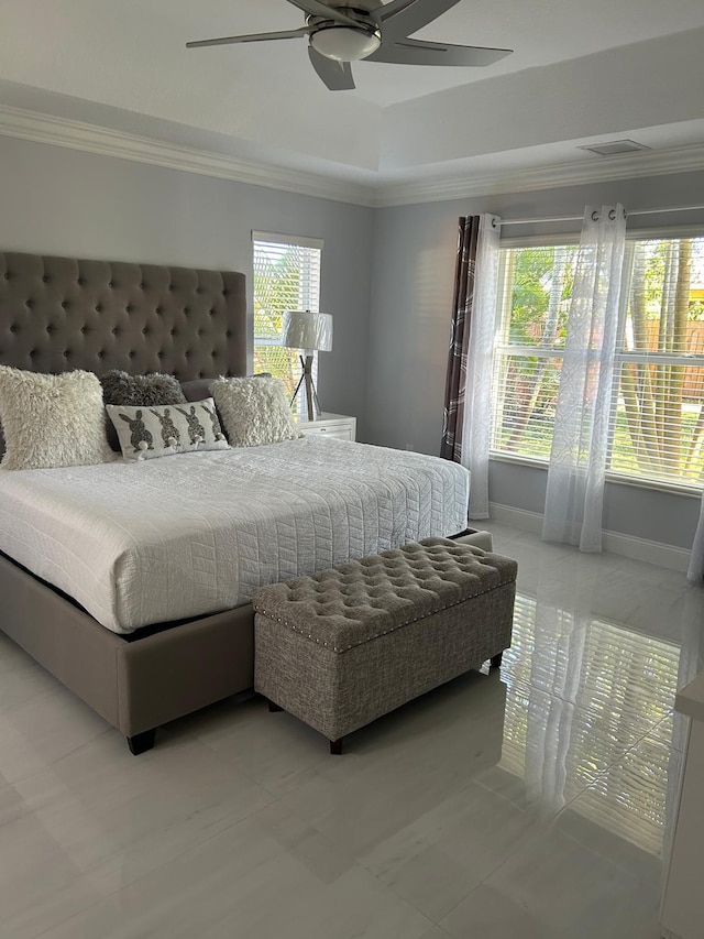 bedroom featuring ornamental molding, a ceiling fan, a raised ceiling, and baseboards