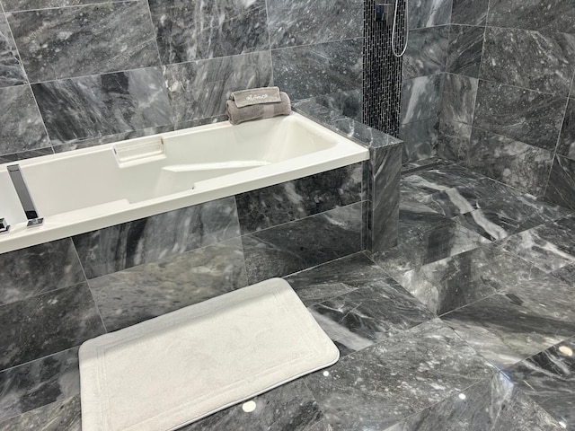 full bath featuring a bath and tile walls