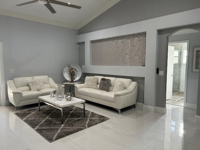 living area featuring lofted ceiling, a ceiling fan, arched walkways, ornamental molding, and baseboards