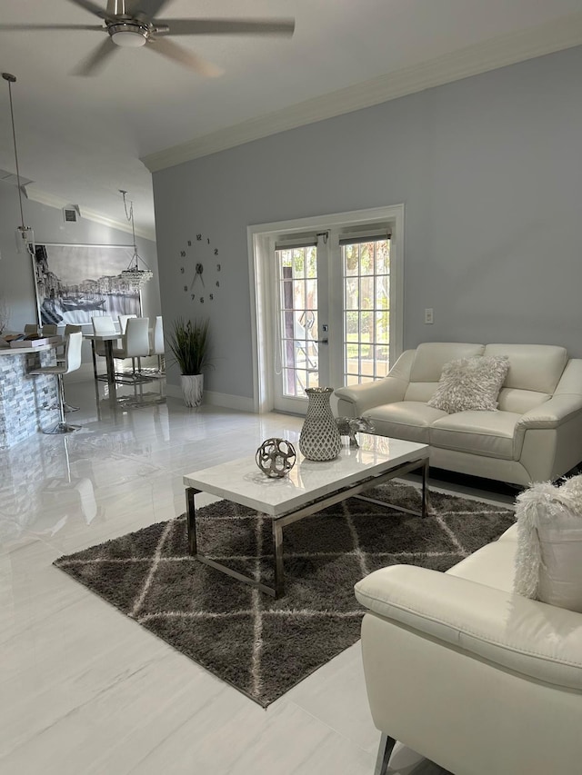living area with ornamental molding, ceiling fan, and french doors