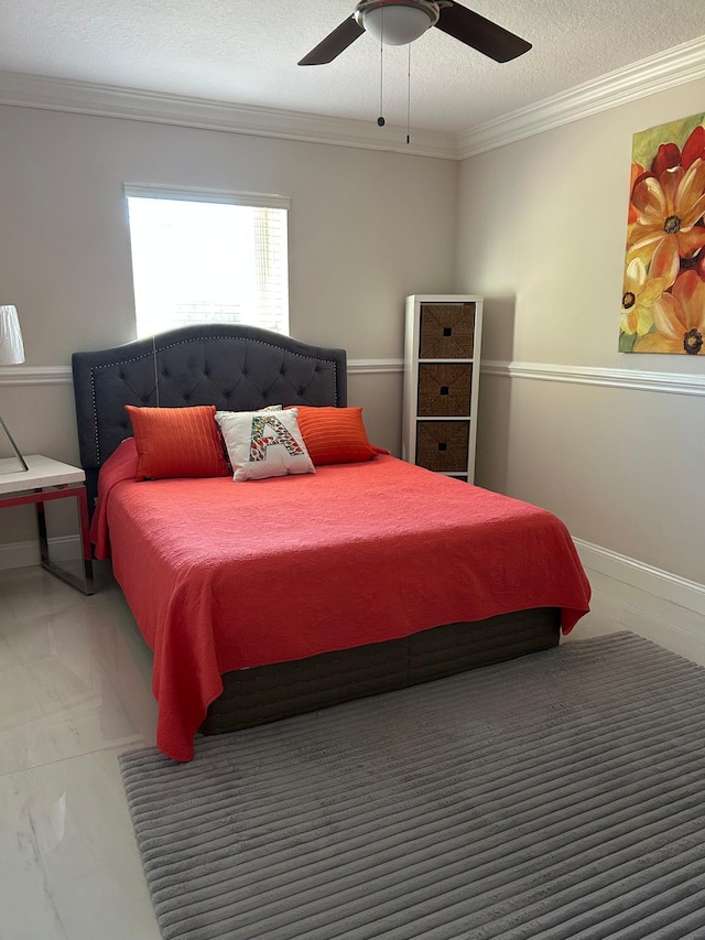 bedroom featuring crown molding, a textured ceiling, ceiling fan, and baseboards