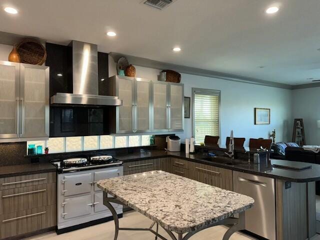 kitchen featuring extractor fan, a kitchen island, sink, a kitchen breakfast bar, and stainless steel dishwasher