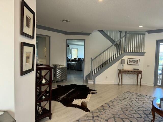 foyer entrance with hardwood / wood-style floors and a wealth of natural light