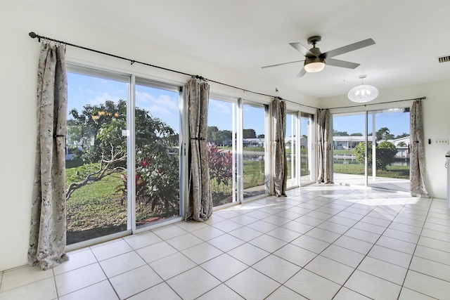 unfurnished sunroom with a wealth of natural light and ceiling fan