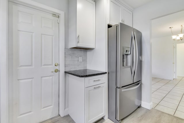 kitchen with white cabinets, a chandelier, backsplash, light hardwood / wood-style floors, and stainless steel refrigerator with ice dispenser