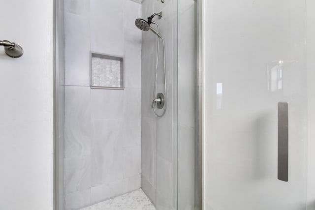 bathroom with a tile shower