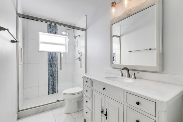 bathroom featuring vanity, a shower with shower door, and toilet