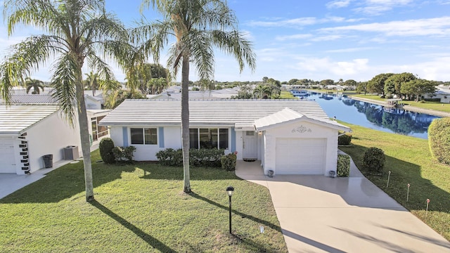 ranch-style home with a water view, a garage, a front yard, and cooling unit