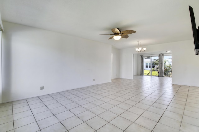 tiled empty room featuring ceiling fan with notable chandelier