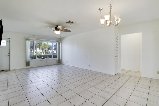 unfurnished living room with ceiling fan with notable chandelier and light tile patterned floors