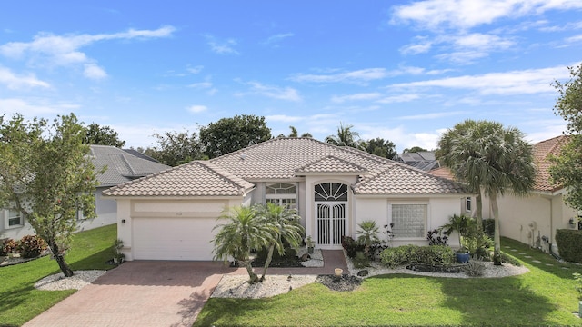 mediterranean / spanish home featuring a garage and a front yard