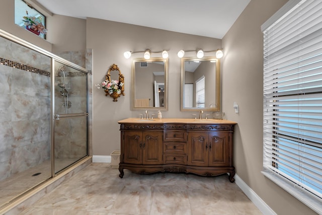 bathroom with vaulted ceiling, vanity, and walk in shower