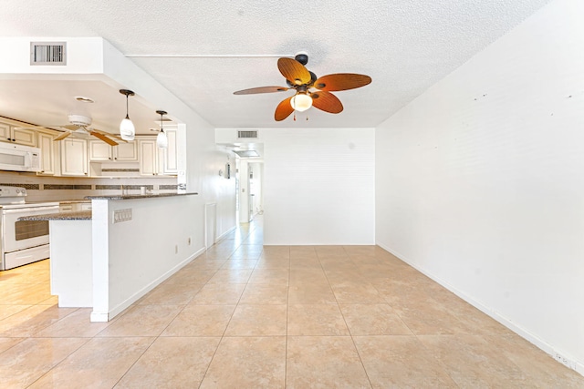 kitchen with pendant lighting, dark stone countertops, kitchen peninsula, cream cabinets, and white appliances