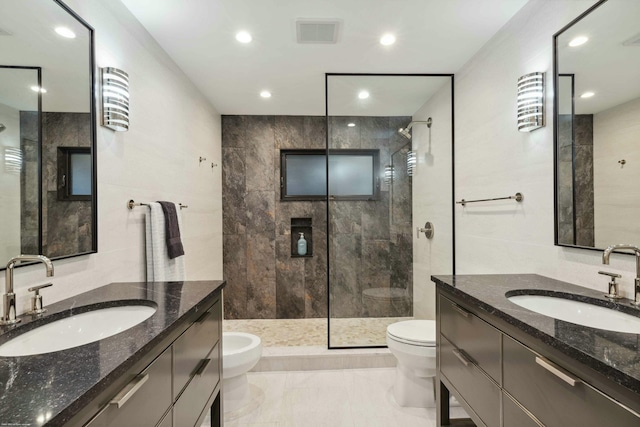 bathroom with vanity, toilet, and a tile shower