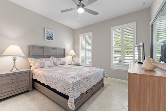 tiled bedroom featuring ceiling fan