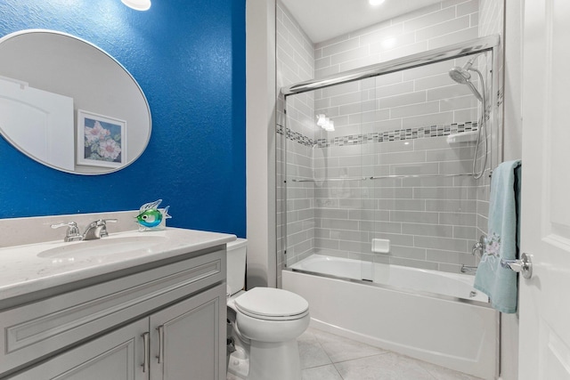 full bathroom with toilet, vanity, bath / shower combo with glass door, and tile patterned flooring