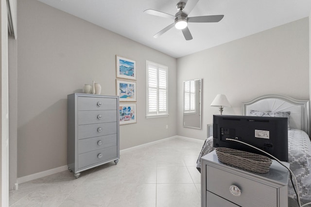 tiled bedroom featuring ceiling fan