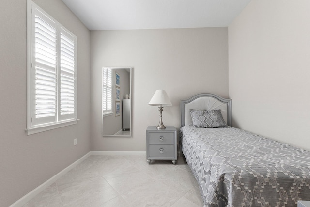 bedroom with light tile patterned floors