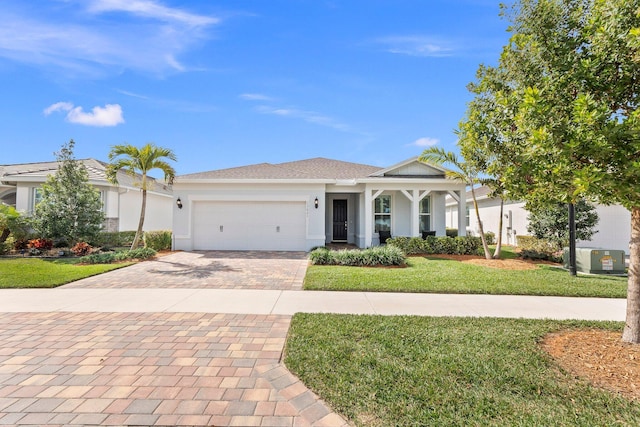 view of front of property featuring a garage and a front yard