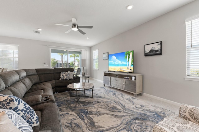 living room with carpet, a healthy amount of sunlight, and ceiling fan