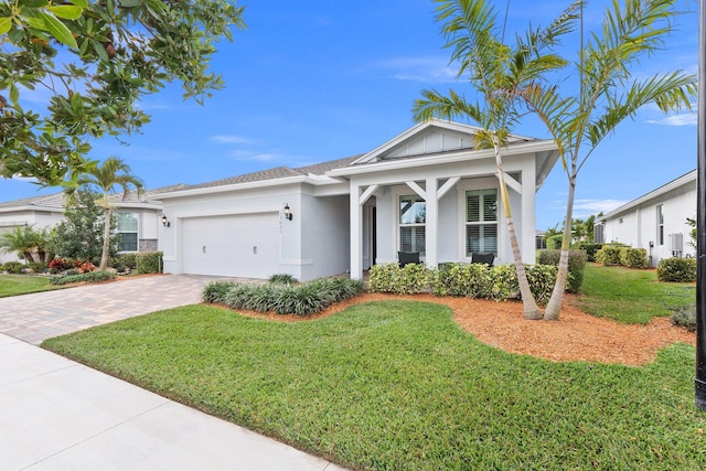 view of front of home with a garage and a front yard