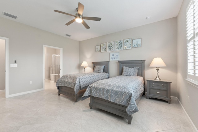 bedroom featuring ensuite bath and ceiling fan