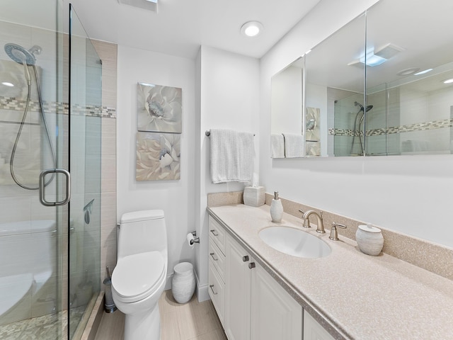 bathroom featuring toilet, vanity, and walk in shower