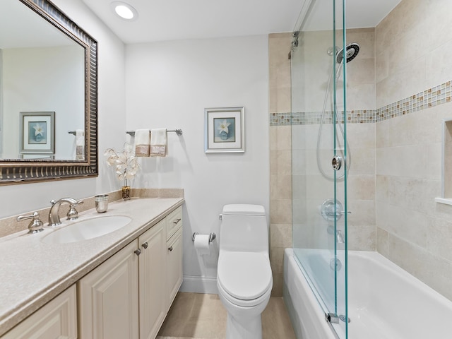 full bathroom featuring toilet, vanity, and bath / shower combo with glass door