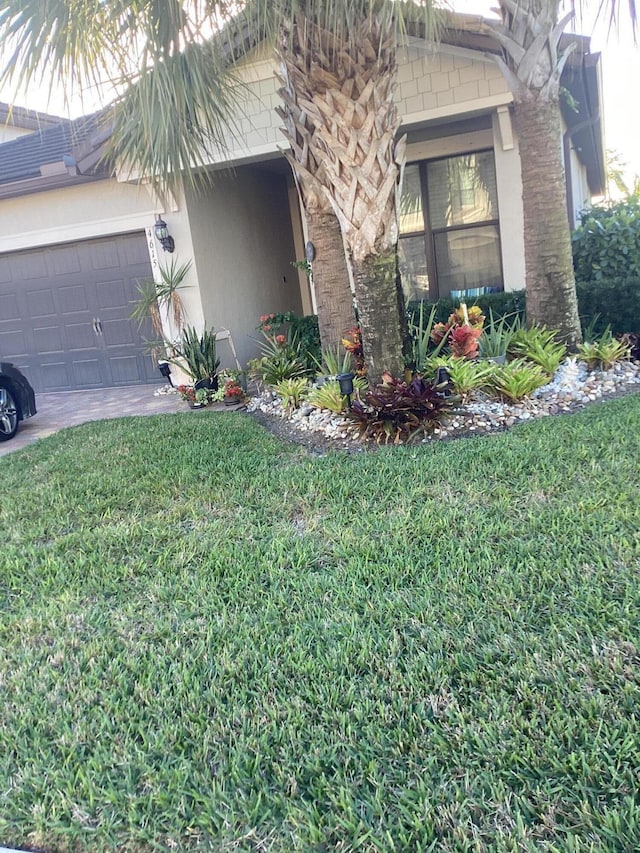 view of side of property with a garage and a yard