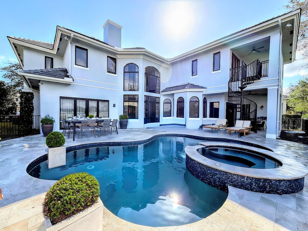 view of pool with an in ground hot tub, ceiling fan, and a patio