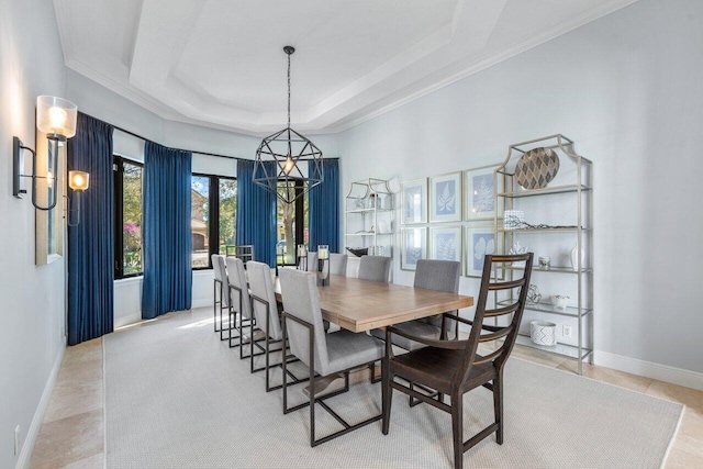 tiled dining space featuring a tray ceiling