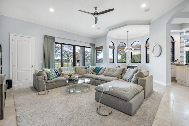 tiled living room featuring ornamental molding and ceiling fan with notable chandelier