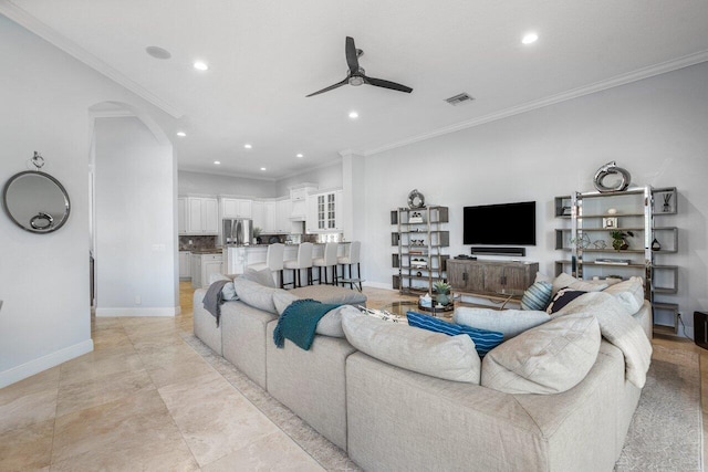 living room with crown molding and ceiling fan