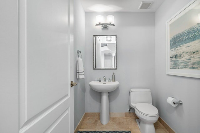 bathroom featuring toilet and tile patterned flooring