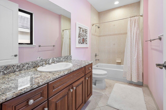 full bathroom featuring tile patterned flooring, vanity, shower / bath combo with shower curtain, and toilet