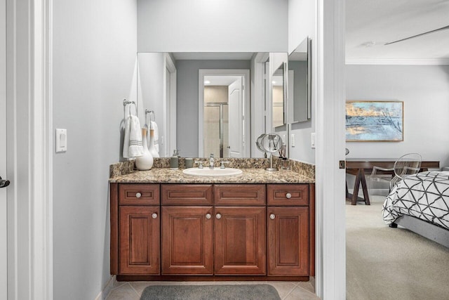 bathroom with tile patterned floors, vanity, and an enclosed shower