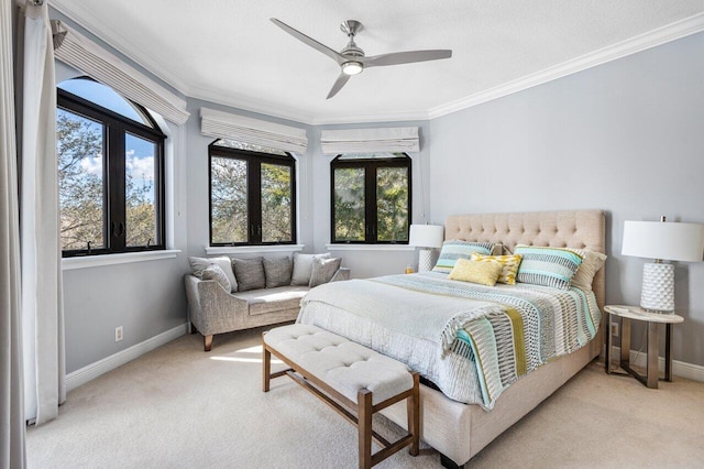 bedroom featuring ornamental molding, light carpet, and ceiling fan