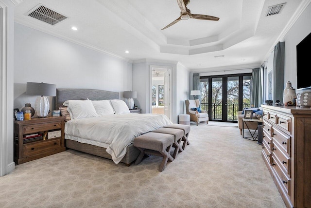 bedroom featuring ornamental molding, a raised ceiling, access to outside, light colored carpet, and french doors