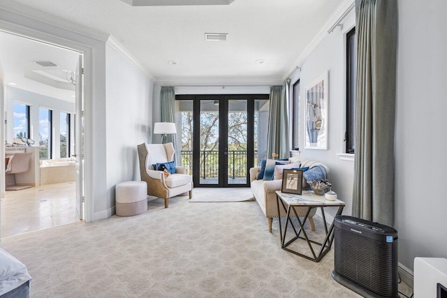 sitting room with french doors, plenty of natural light, and crown molding