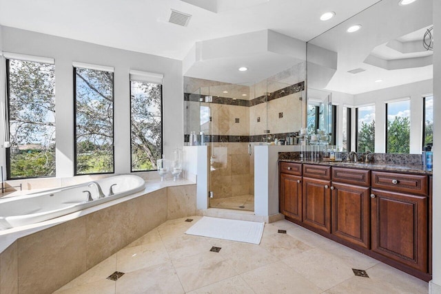 bathroom with vanity and separate shower and tub