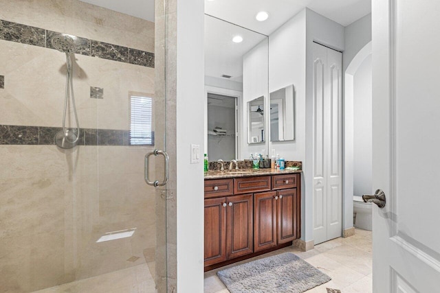 bathroom featuring vanity, tile patterned floors, and walk in shower