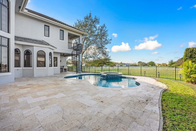 view of swimming pool featuring an in ground hot tub and a patio