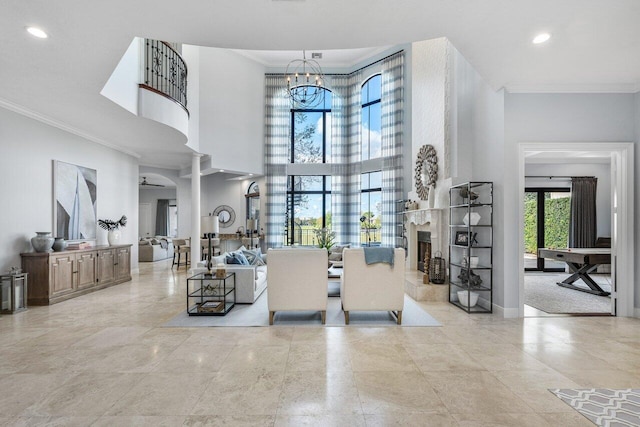 interior space with an inviting chandelier, ornamental molding, ornate columns, and a high ceiling