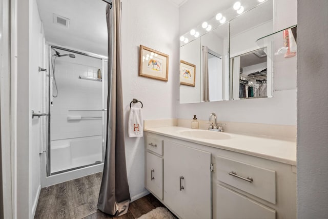 bathroom featuring vanity, hardwood / wood-style floors, and an enclosed shower