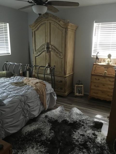 bedroom with ceiling fan and dark hardwood / wood-style floors