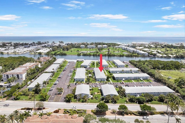 birds eye view of property with a water view