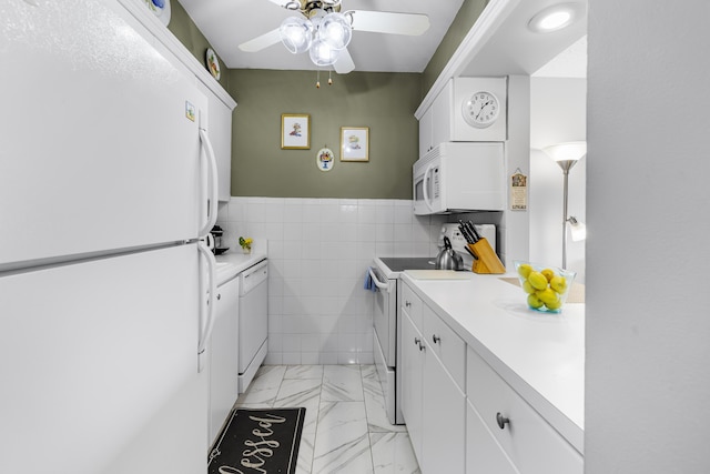 kitchen featuring ceiling fan, white appliances, tile walls, and white cabinets