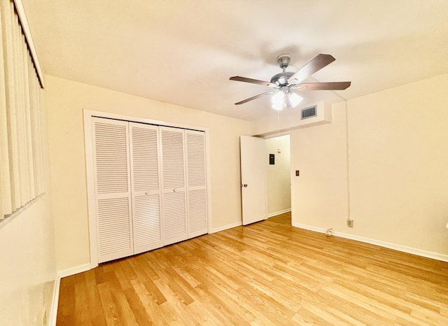 unfurnished bedroom featuring ceiling fan, light hardwood / wood-style floors, and a closet