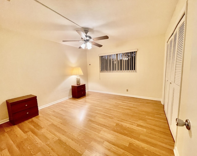 unfurnished bedroom featuring ceiling fan, a closet, and light hardwood / wood-style flooring