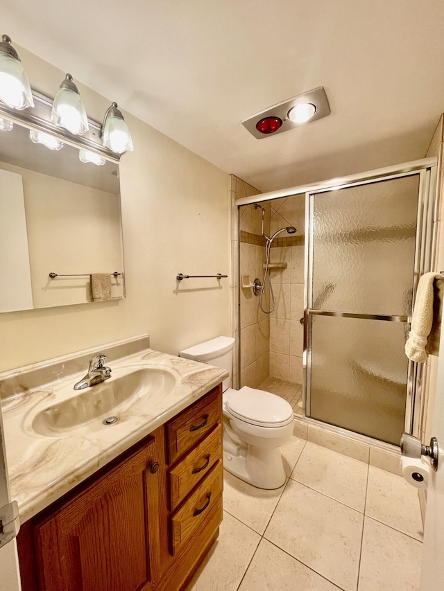 bathroom featuring vanity, an enclosed shower, tile patterned floors, and toilet